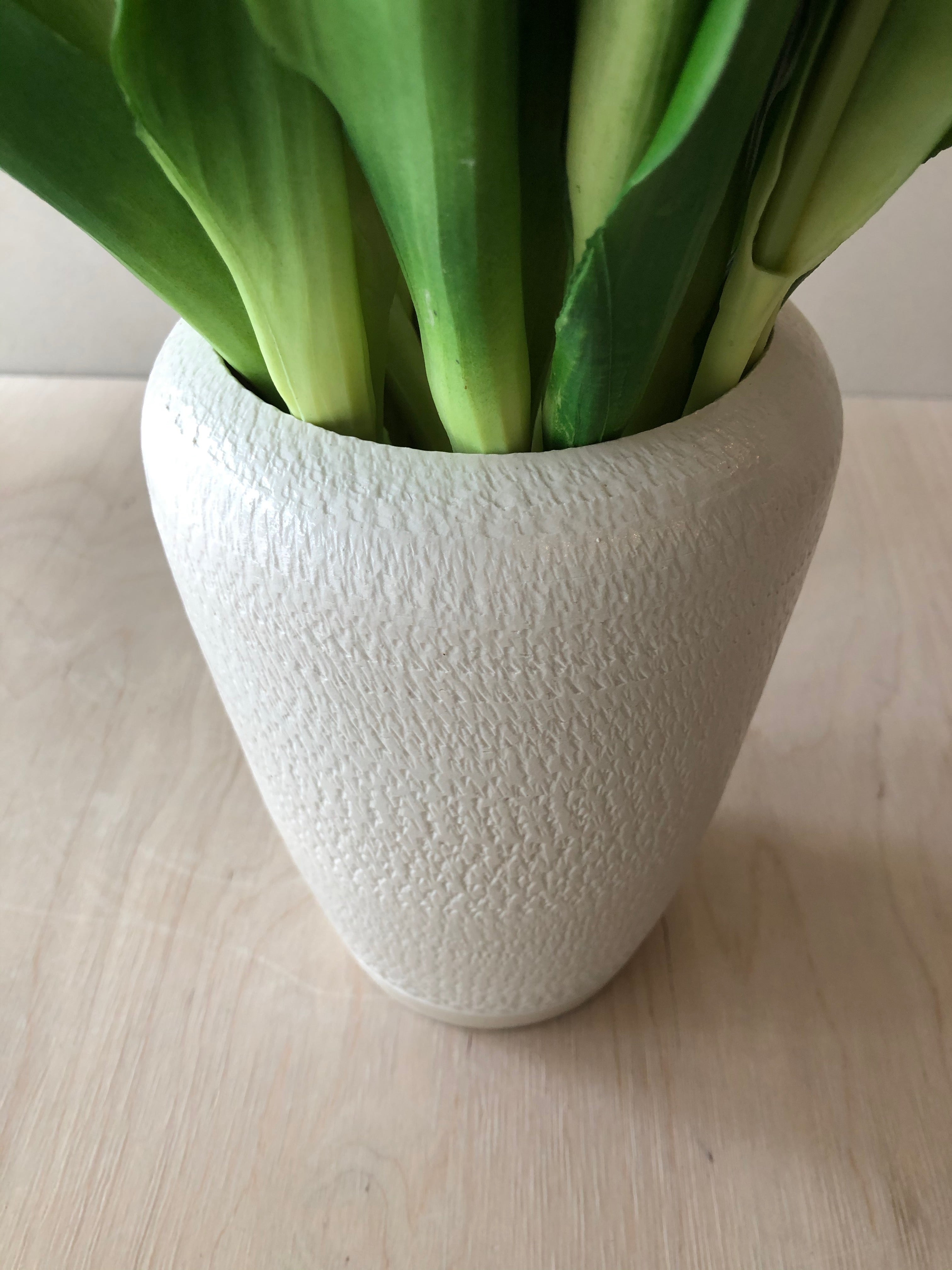 Tall white vase with chattering decoration