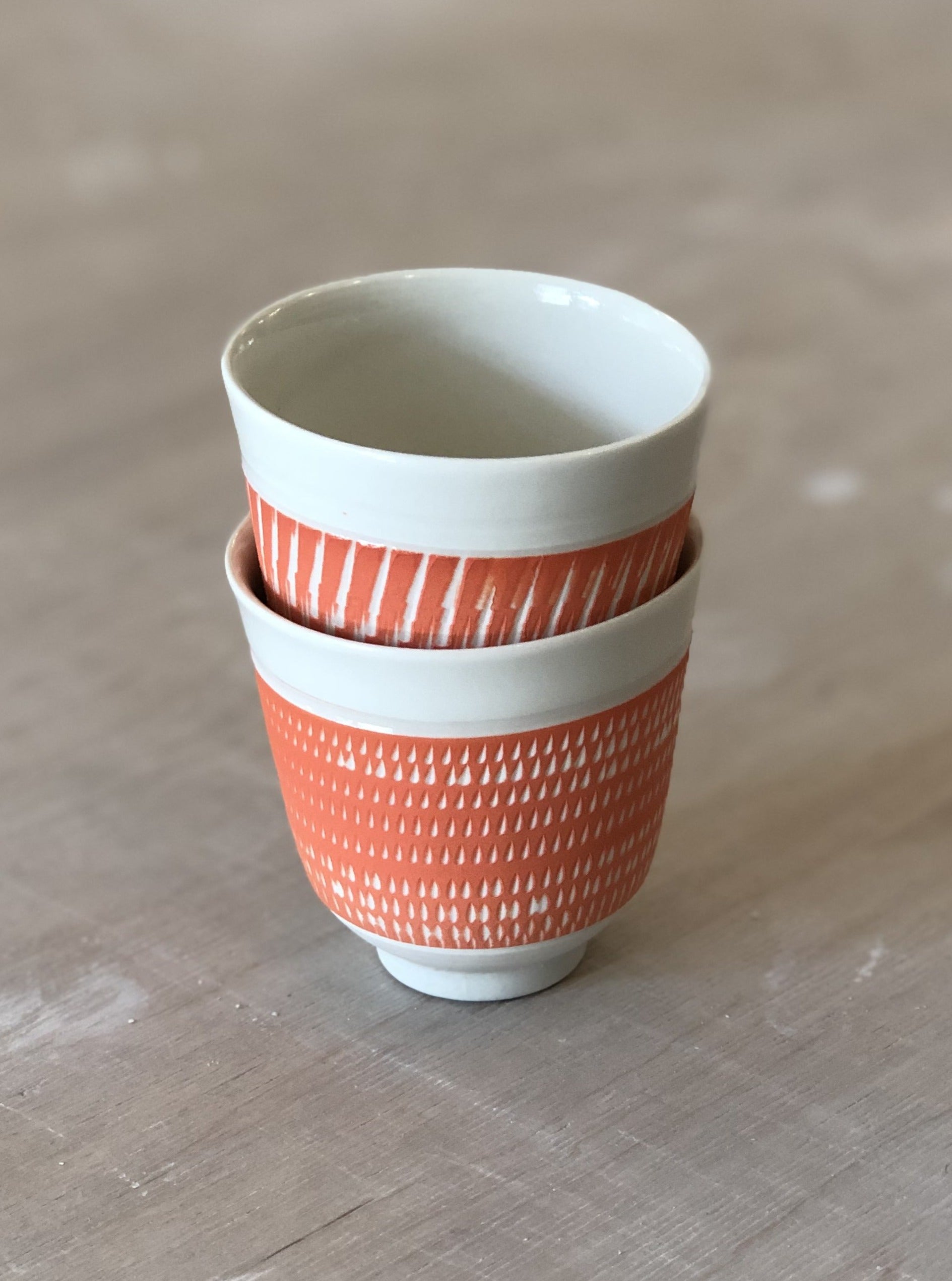 Porcelain cup with chattering decoration /  Orange