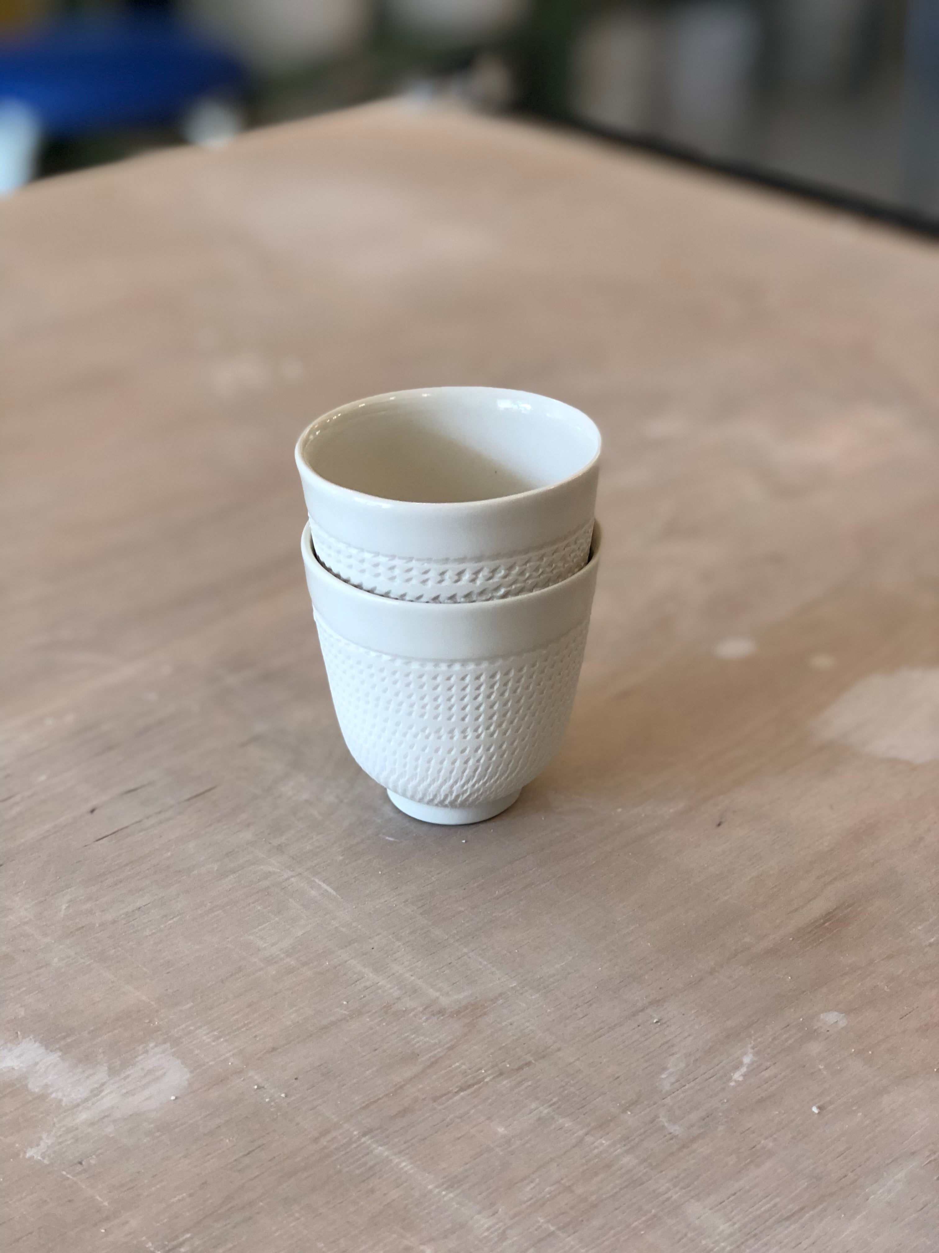 Porcelain cup with chattering decoration /  Gray