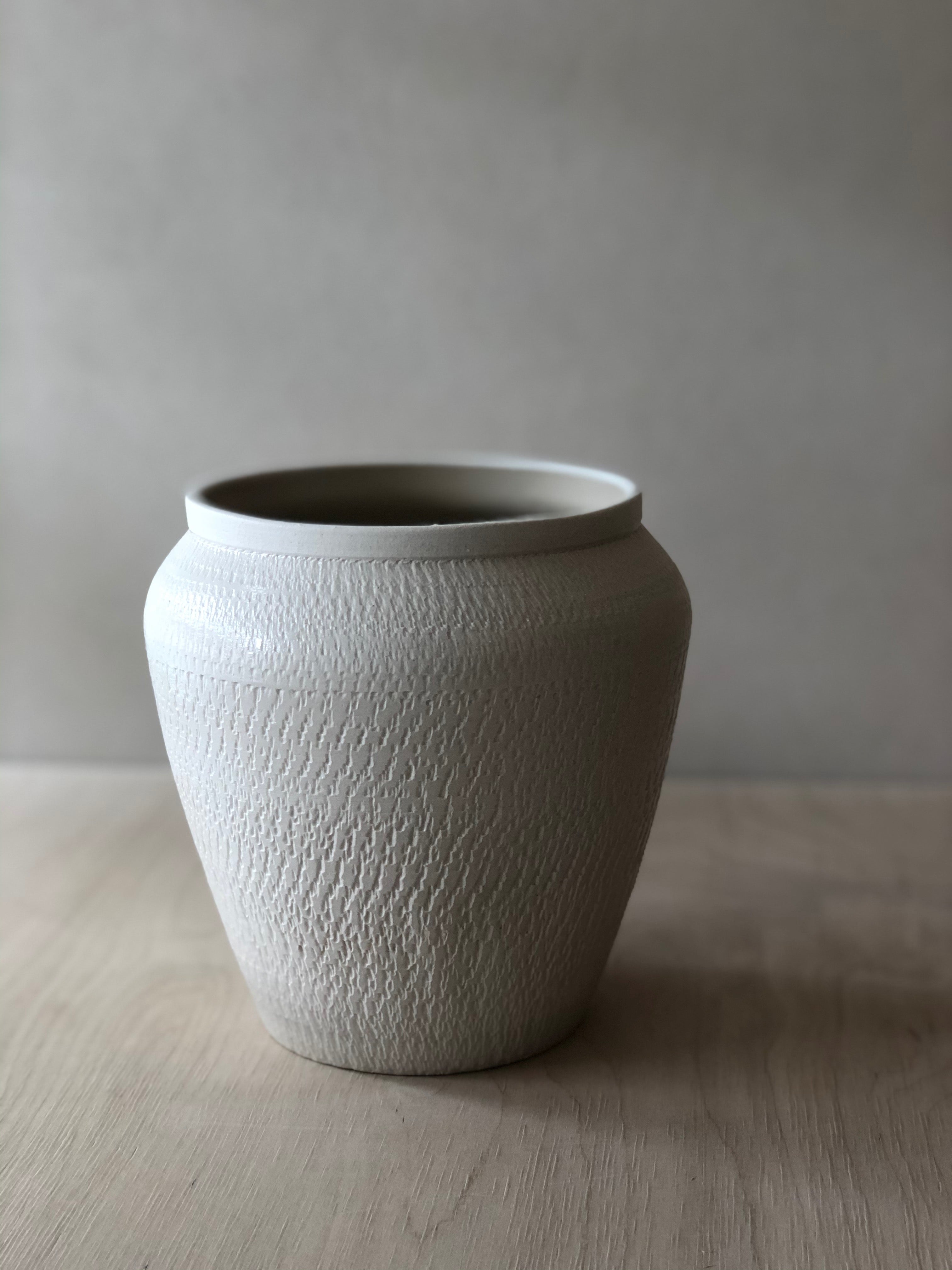 Small white vase with chattering decoration