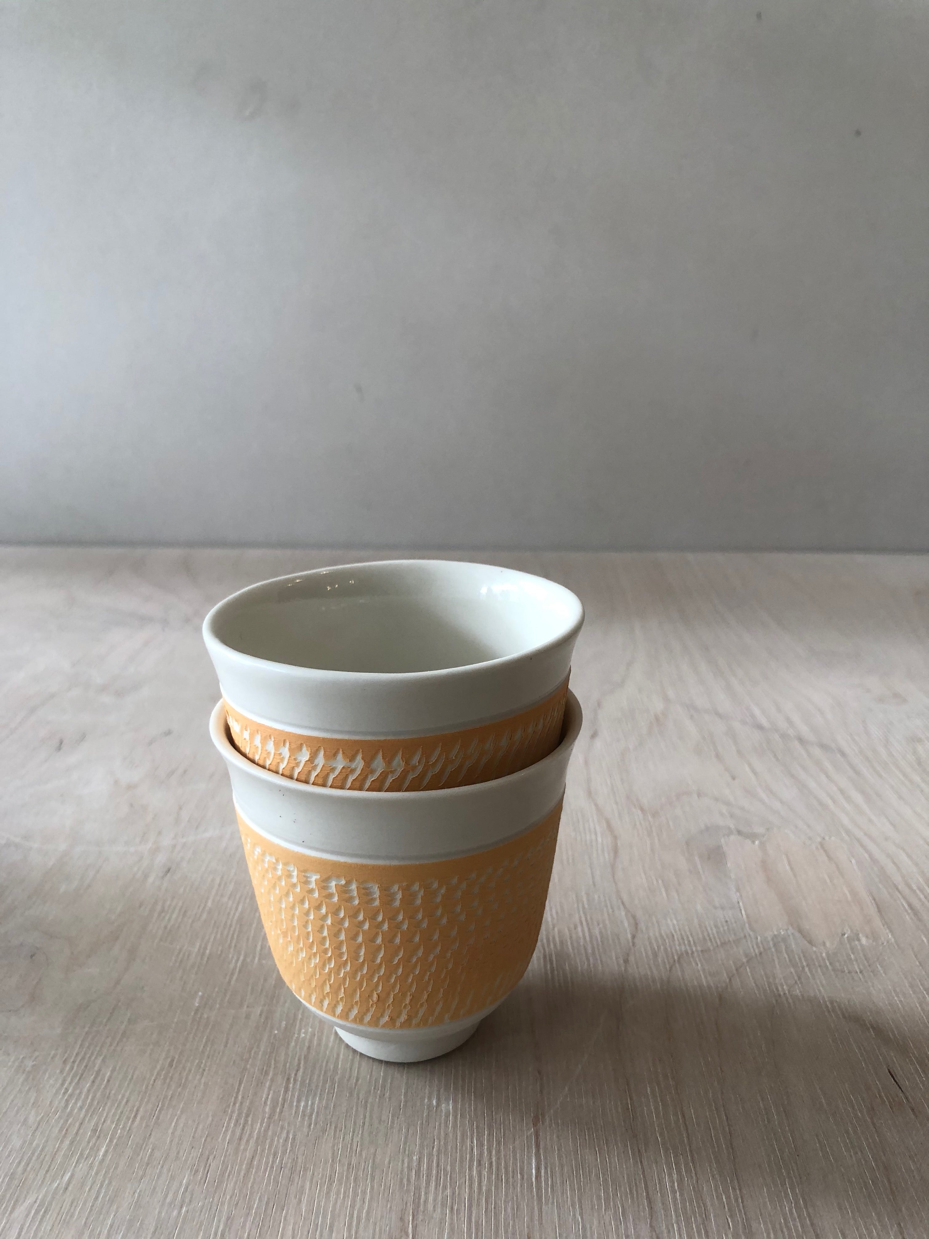 Porcelain cup with chattering decoration /  Yellow